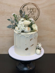 white floral drip cake