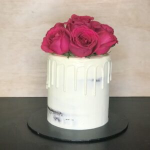 semi naked white drip cake with red roses