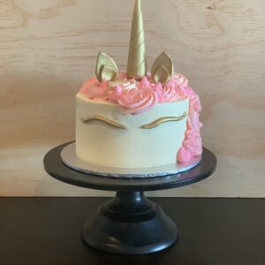 small unicorn cake with pink and gold