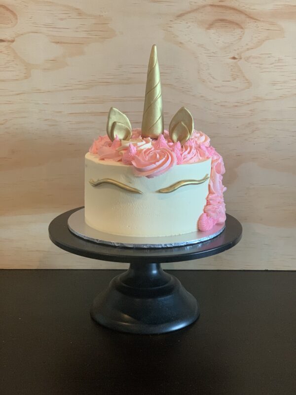 small unicorn cake with pink and gold