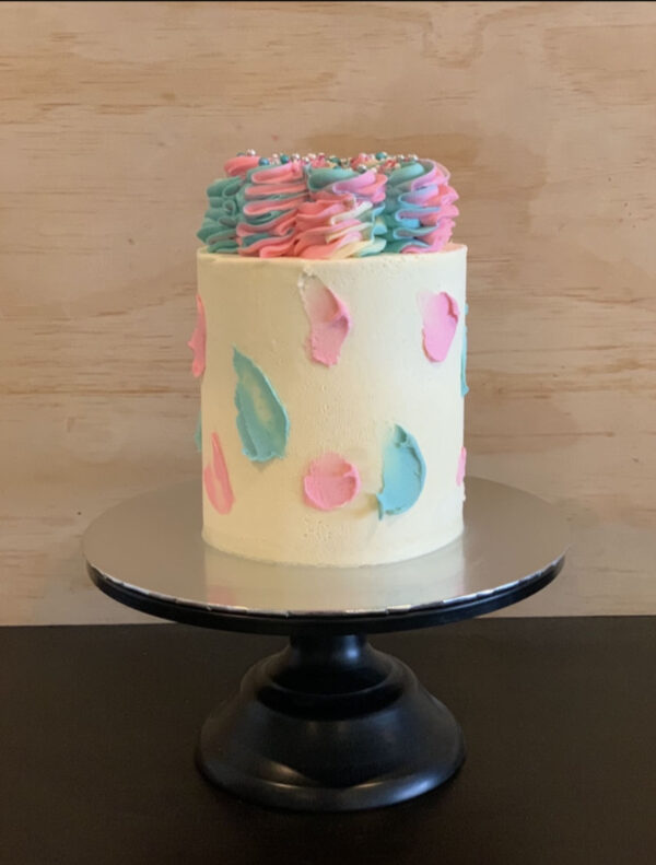 gender reveal cake with pink and blue swirls